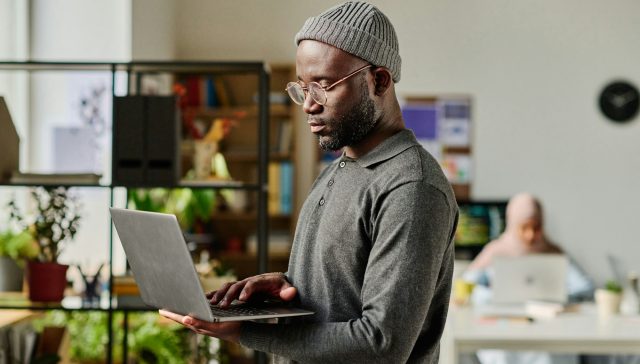 Developer using laptop in IT office