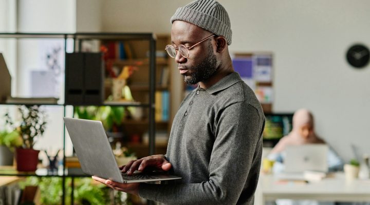 Developer using laptop in IT office