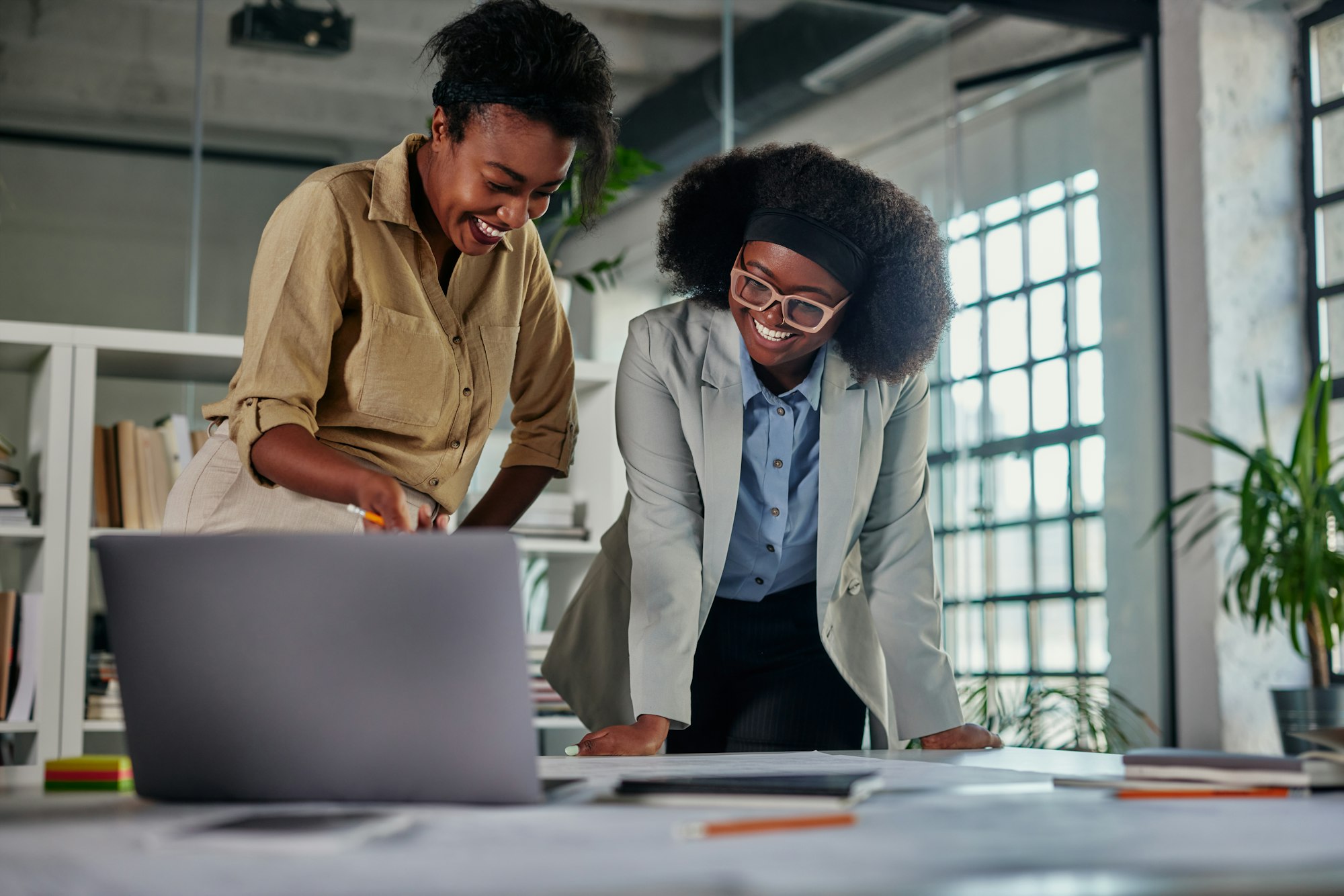 Two african businesswomen working in office and using technology