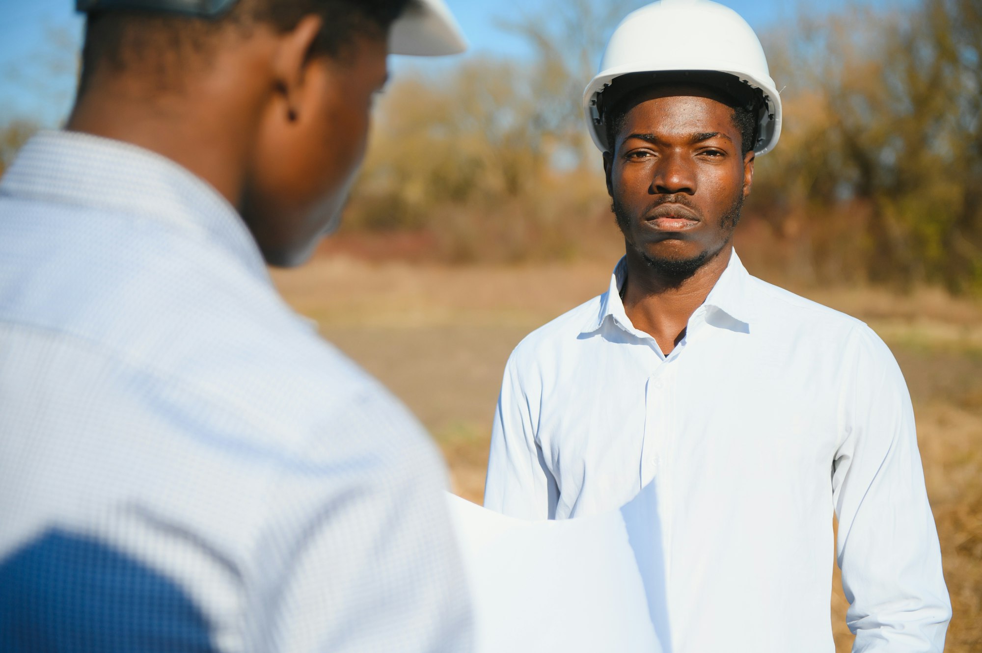 two male surveyors working at mining site
