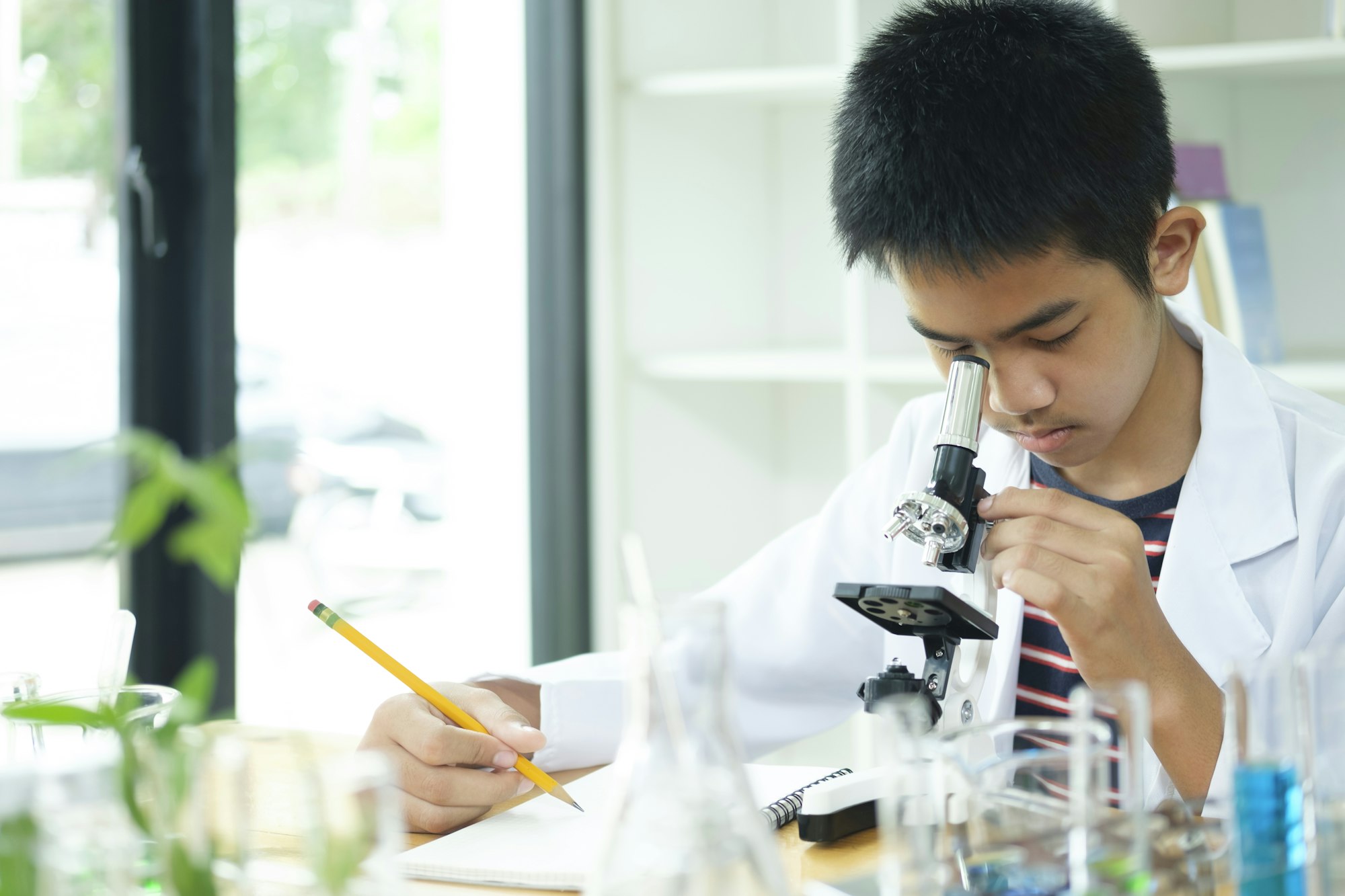 Young Scientist: Elementary Schoolboy Explores with Microscope
